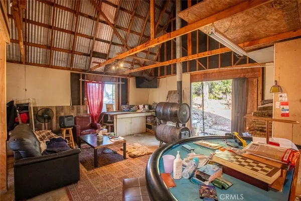 an aerial view of a house with a bed and wooden floor