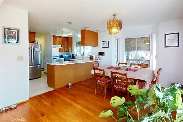a living room with furniture a flat screen tv and a chandelier