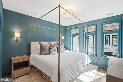 a bedroom with a bed and a night stand