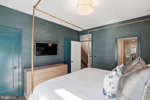 a bedroom with a bed and a dresser