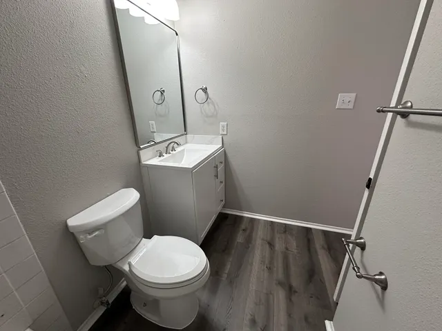 a white toilet sitting next to a bathroom sink