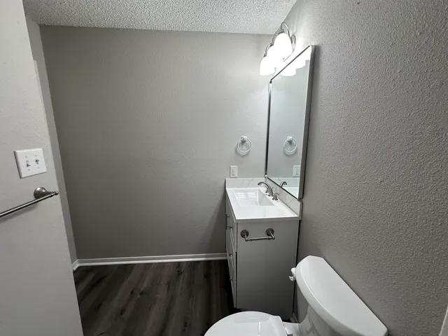 a bathroom with a toilet sink and mirror