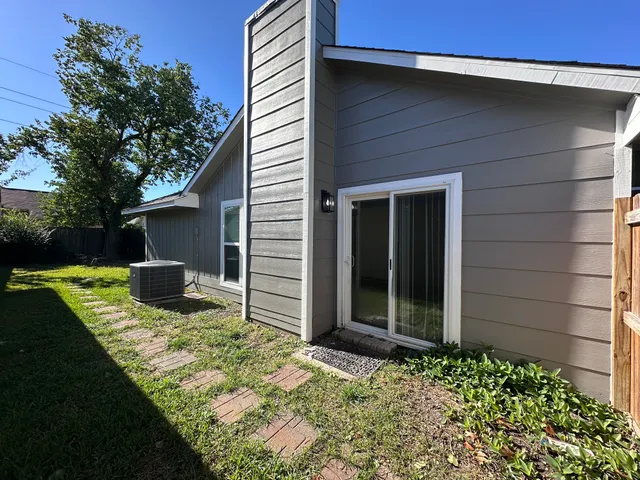a view of an house with backyard space and garden
