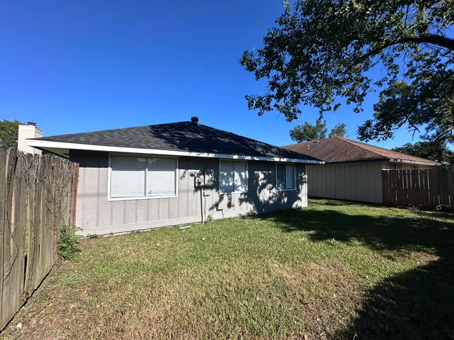 a view of a house with a yard and tree