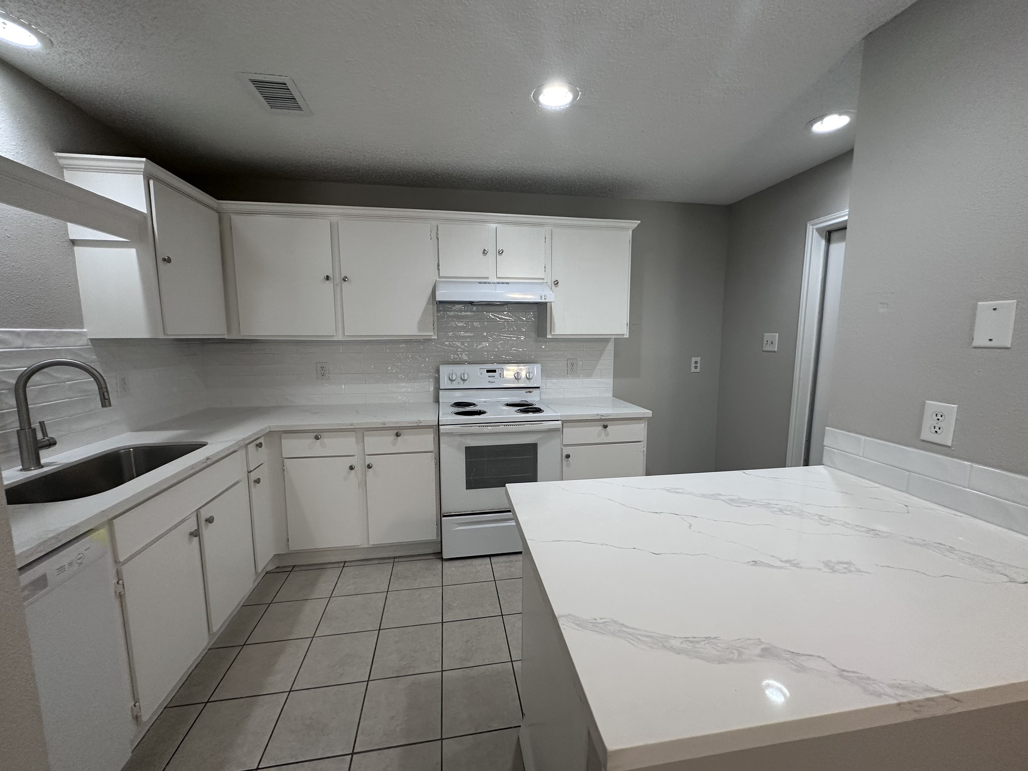 3130 Cottonshire Drive Spring, TX 77373 - Photo 7 of 32 a kitchen with a sink a stove top oven and cabinets
