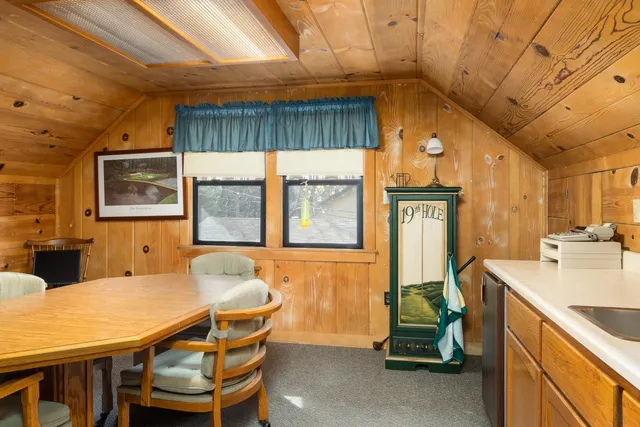 a dining room with a table chairs and a kitchen view