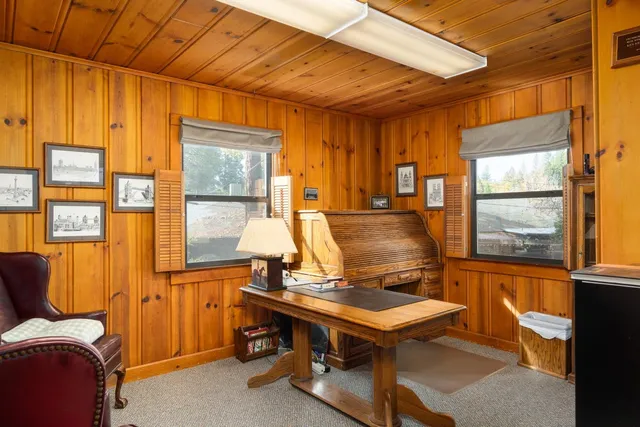 a room with furniture pool table and windows