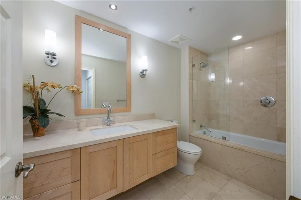410 Bayfront Place, Unit 2405 Naples, FL 34102 - Photo 11 of 22 a bathroom with a double vanity sink toilet mirror and shower