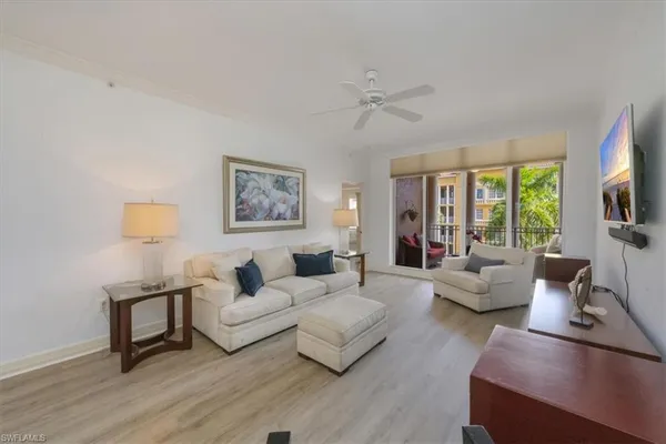 a living room with furniture and a large window