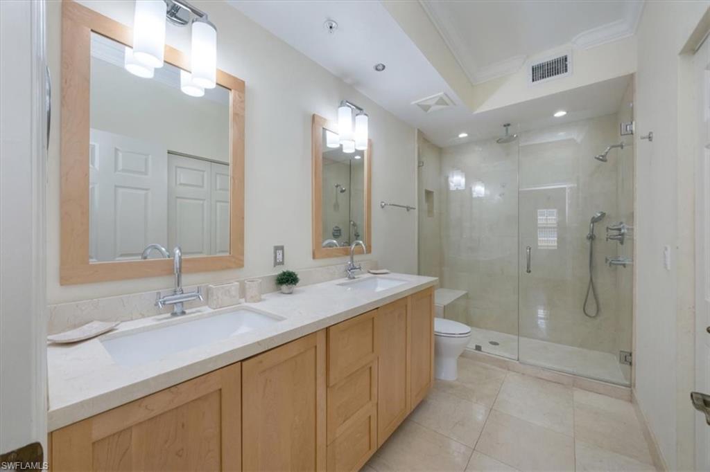 410 Bayfront Place, Unit 2405 Naples, FL 34102 - Photo 9 of 22 a bathroom with a double vanity sink mirror double and shower