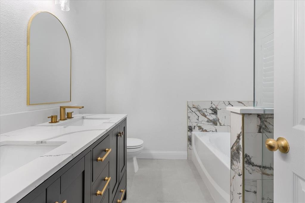 3701 Regency Circle Fort Worth, TX 76137 - Photo 15 of 31 a bathroom with a sink and mirror with toilet