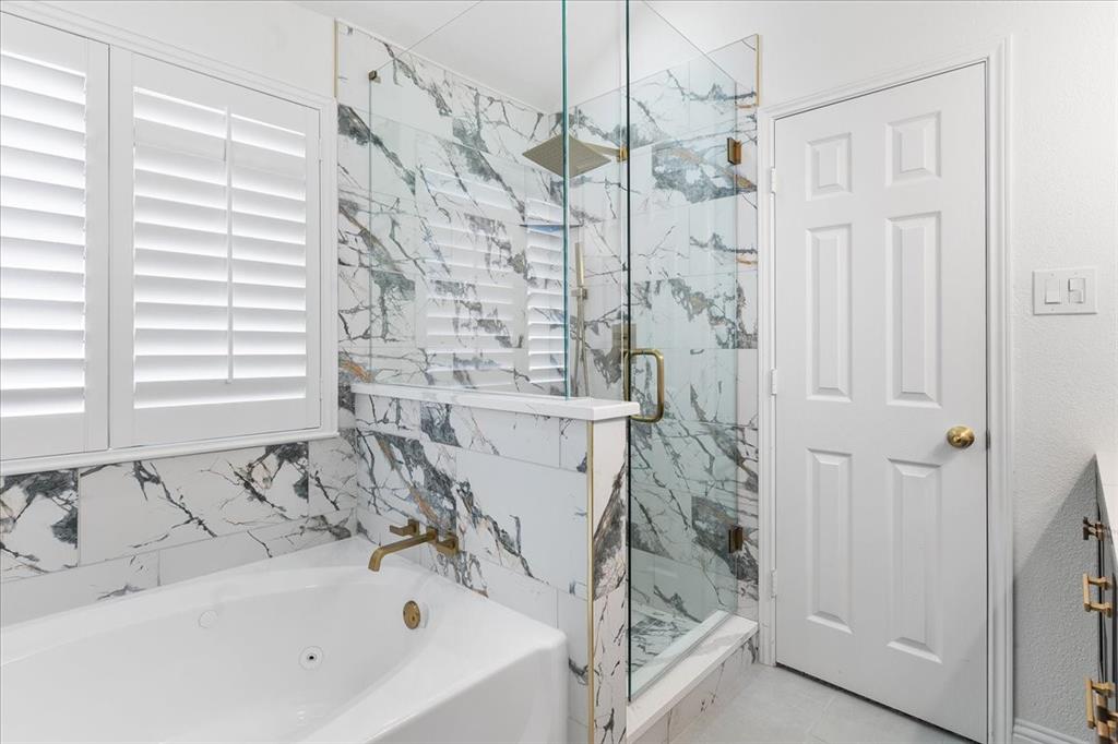 3701 Regency Circle Fort Worth, TX 76137 - Photo 16 of 31 a bathroom with a bathtub and a shower