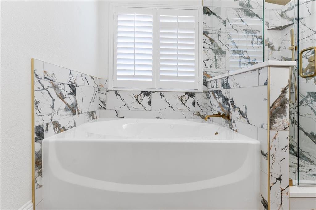 3701 Regency Circle Fort Worth, TX 76137 - Photo 17 of 31 a bath tub sitting in a bathroom next to a window