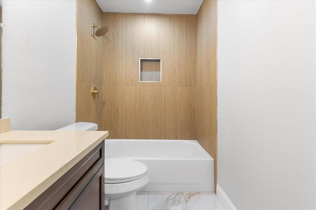 3701 Regency Circle Fort Worth, TX 76137 - Photo 20 of 31 a bathroom with a sink a toilet and shower