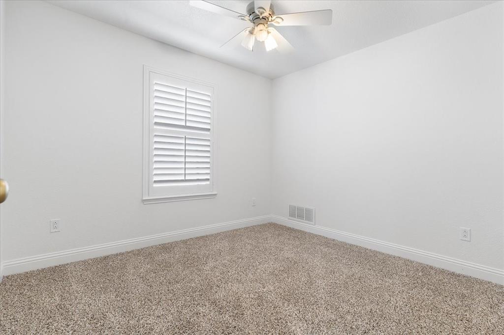 3701 Regency Circle Fort Worth, TX 76137 - Photo 23 of 31 an empty room with a window and a fan