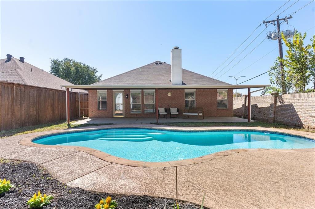 3701 Regency Circle Fort Worth, TX 76137 - Photo 28 of 31 a swimming pool with outdoor seating and yard