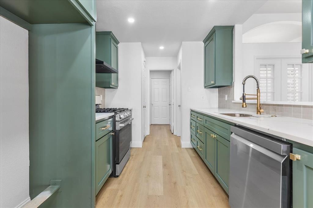 3701 Regency Circle Fort Worth, TX 76137 - Photo 3 of 31 a kitchen with stainless steel appliances granite countertop a sink and a refrigerator