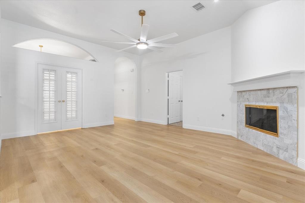 3701 Regency Circle Fort Worth, TX 76137 - Photo 8 of 31 a view of an empty room with chandelier fan and fire place