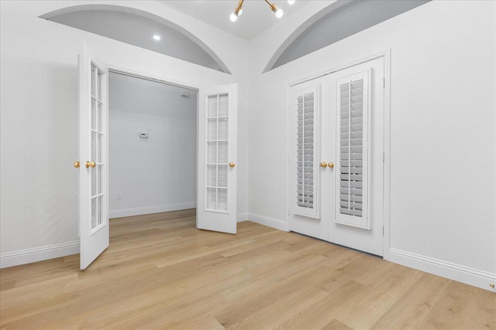 3701 Regency Circle Fort Worth, TX 76137 - Photo 10 of 31 an empty room with wooden floor cabinet and windows