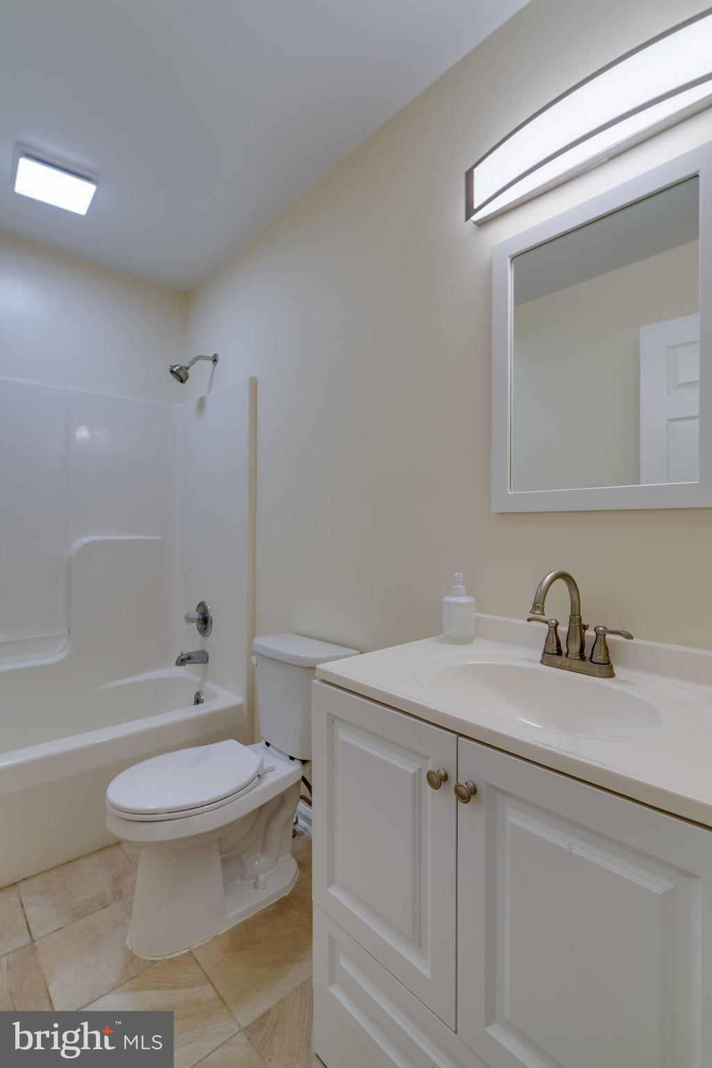 25 Tupelo Street Lititz, PA 17543 - Photo 20 of 20 a bathroom with a granite countertop toilet a sink and a bathtub