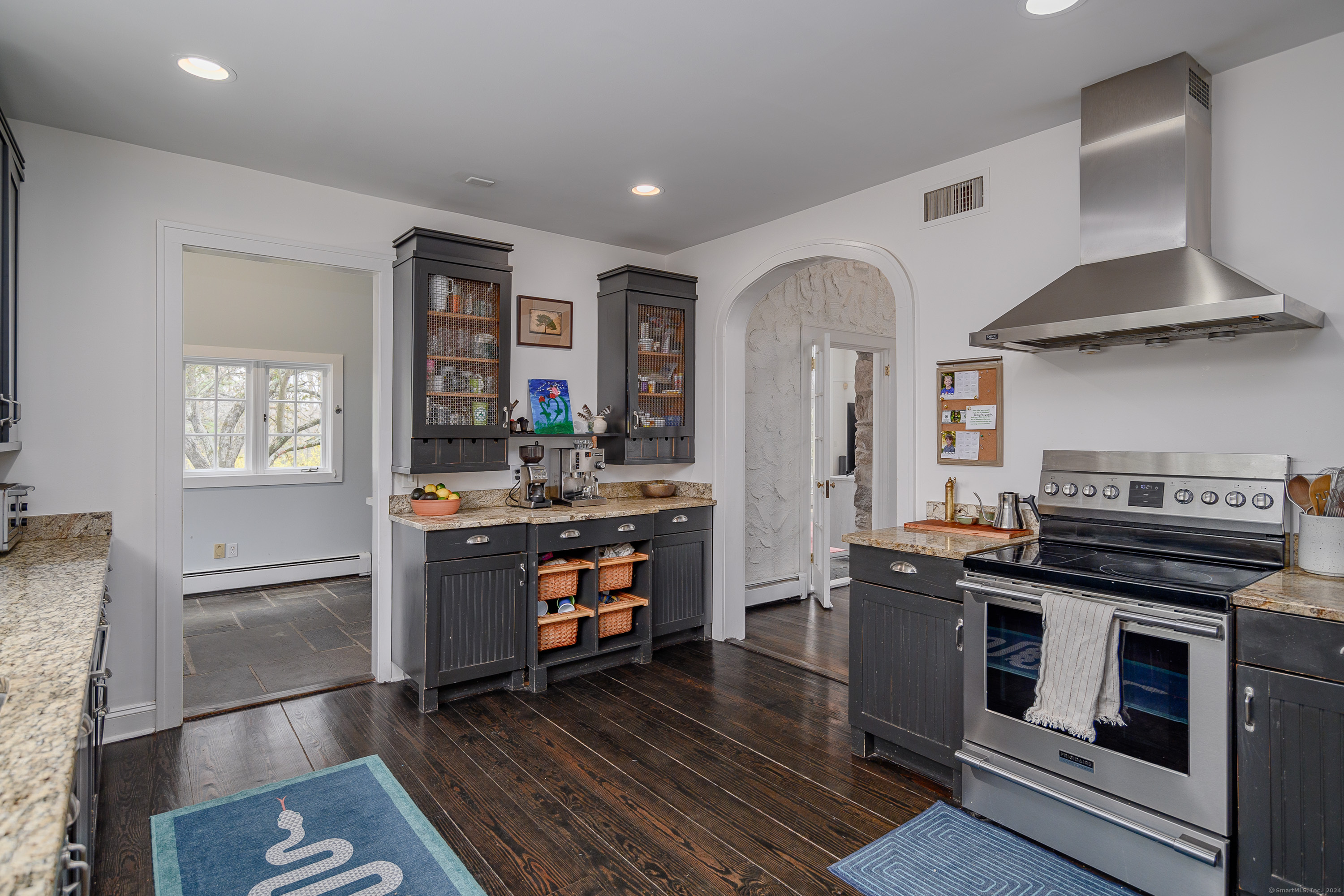 58 Woodchuck Lane Ridgefield, CT 06877 - Photo 18 of 38 a kitchen with stainless steel appliances a stove a refrigerator and cabinets