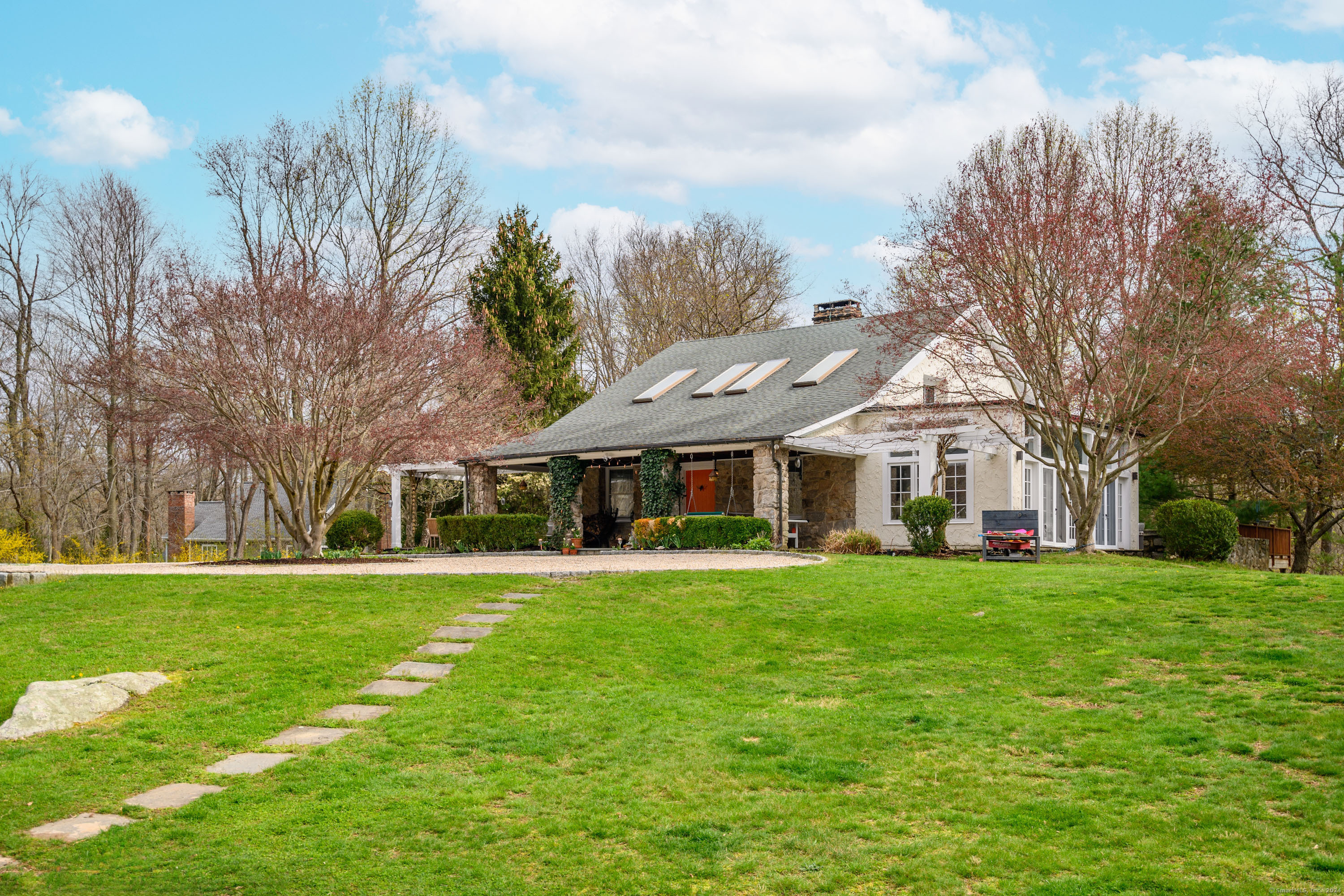 58 Woodchuck Lane Ridgefield, CT 06877 - Photo 2 of 38 a front view of a building with a garden