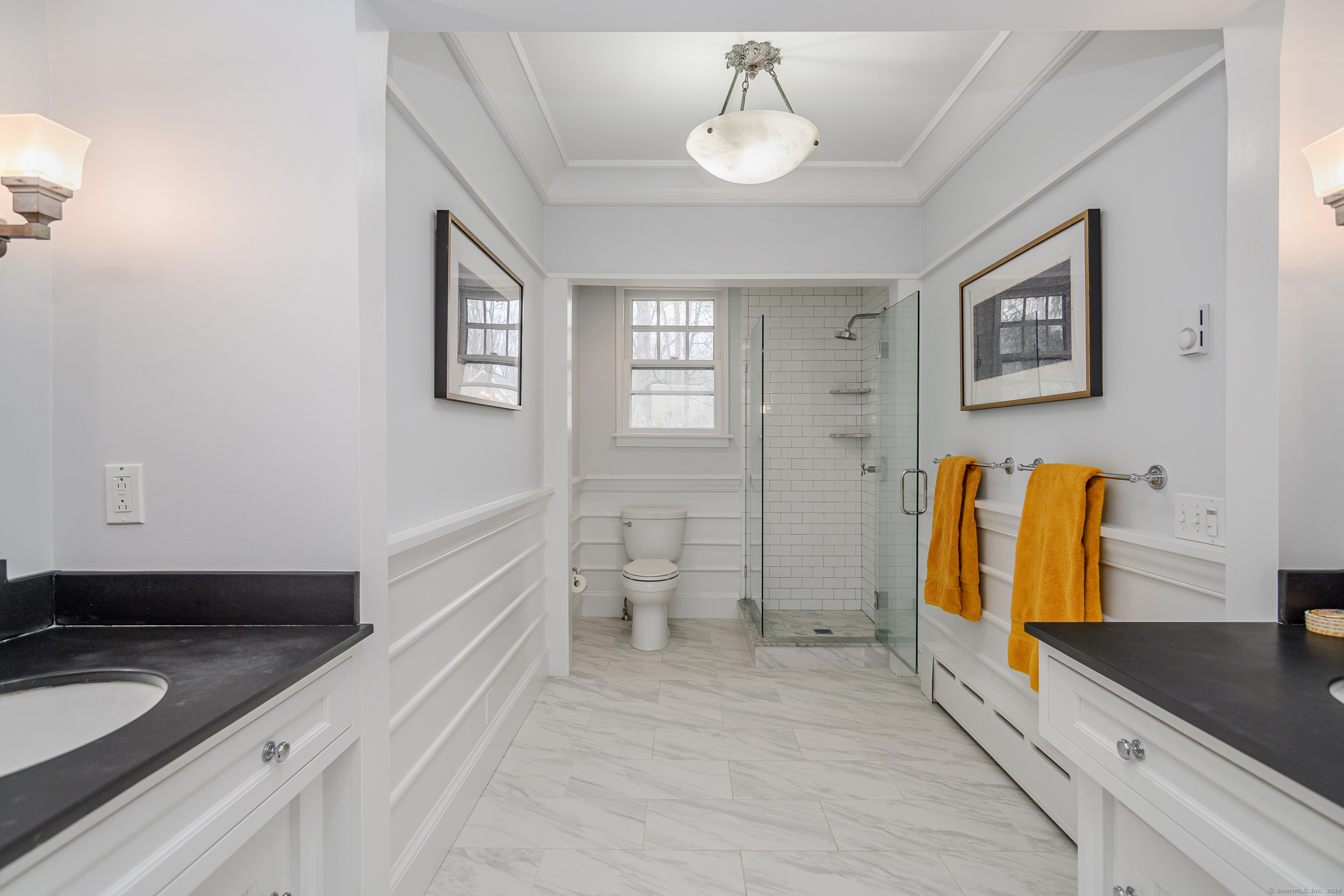58 Woodchuck Lane Ridgefield, CT 06877 - Photo 28 of 38 a spacious bathroom with a granite countertop sink and a mirror