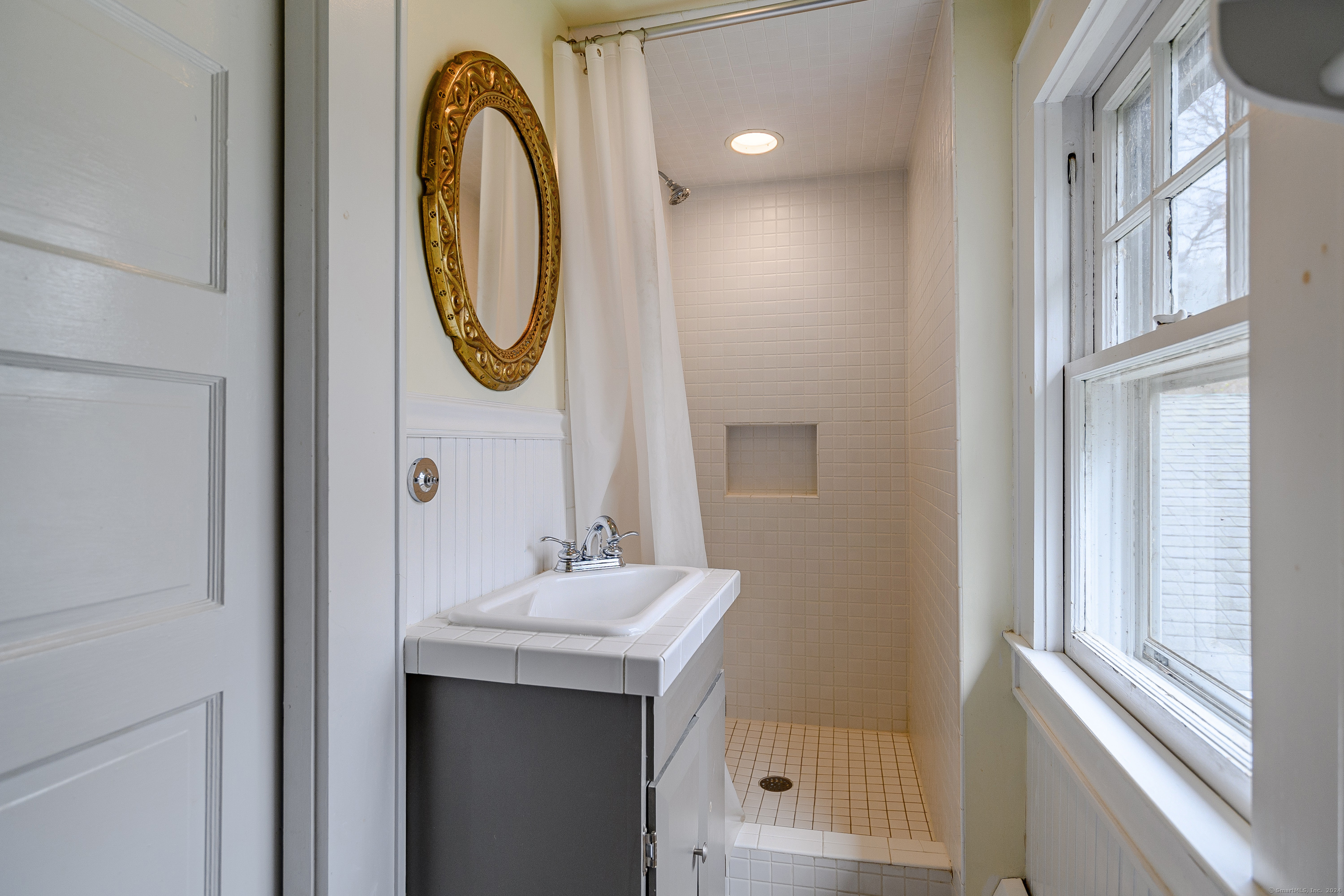 58 Woodchuck Lane Ridgefield, CT 06877 - Photo 32 of 38 a bathroom with a sink and a mirror