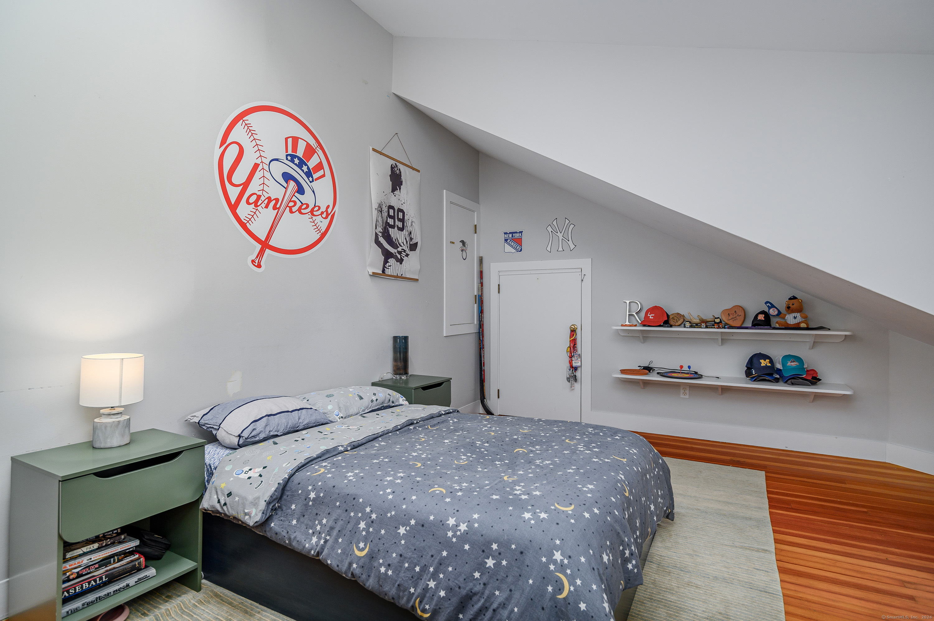 58 Woodchuck Lane Ridgefield, CT 06877 - Photo 33 of 38 a bedroom with a bed and wooden floor