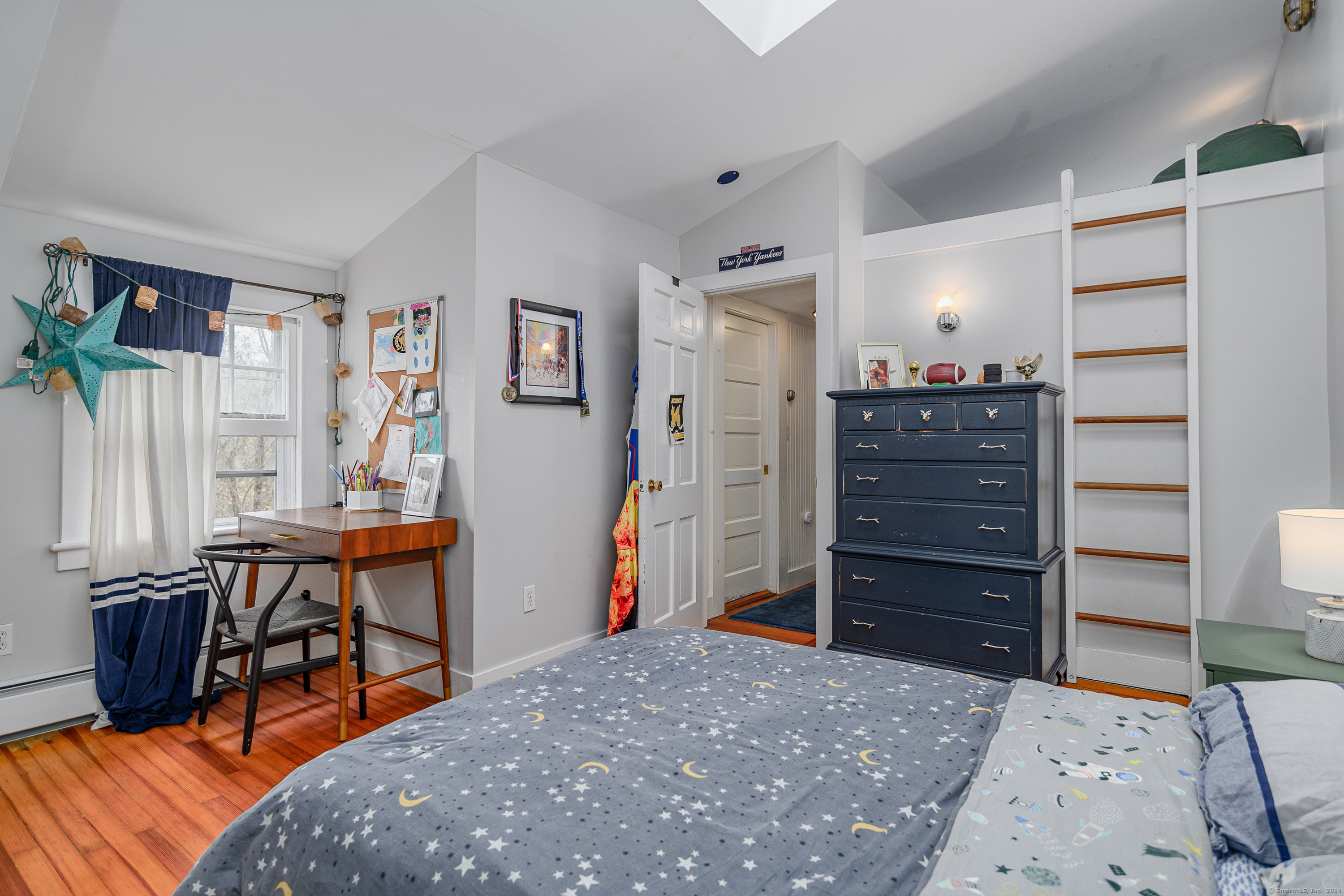 58 Woodchuck Lane Ridgefield, CT 06877 - Photo 34 of 38 a bed room with a bed and a table