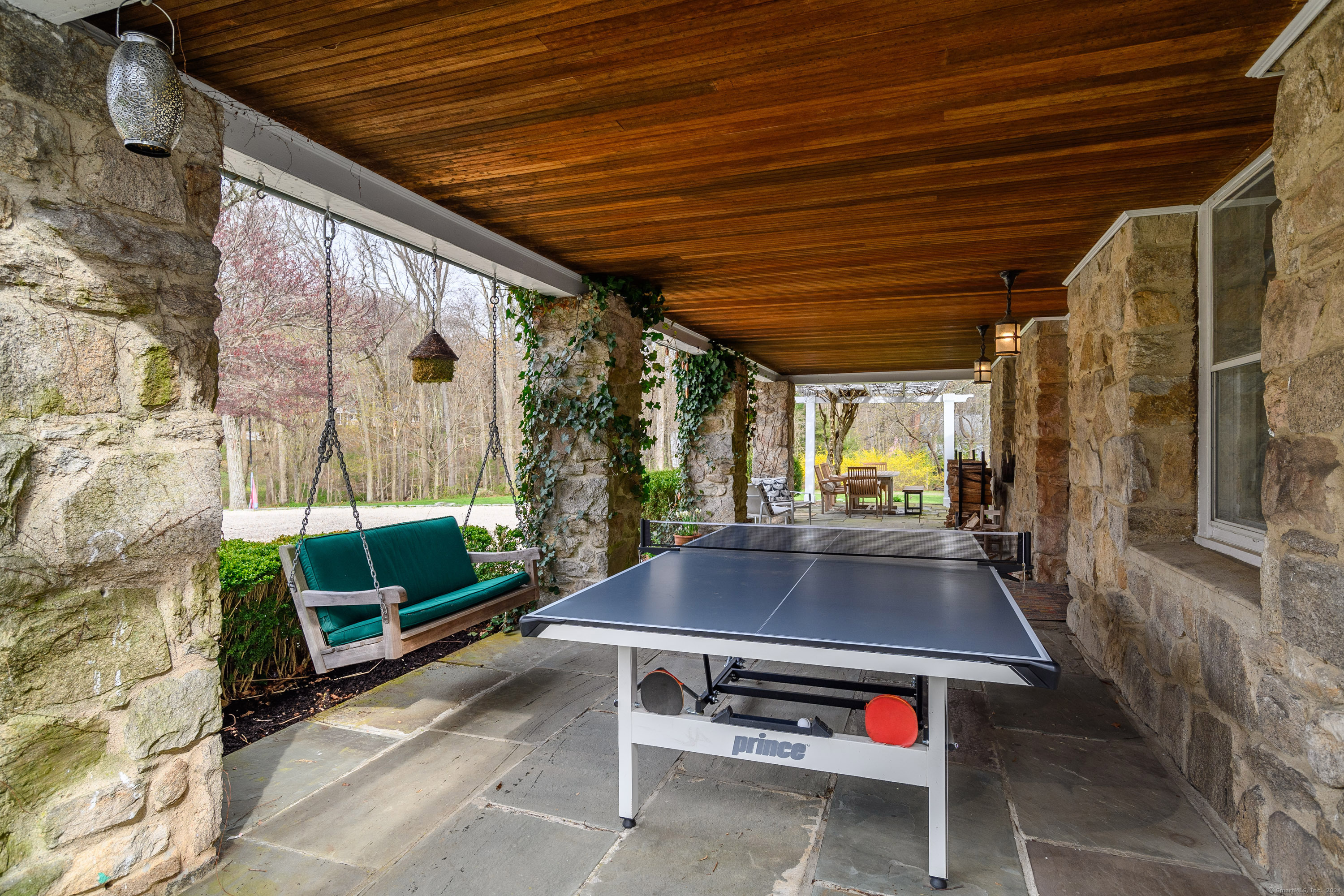 58 Woodchuck Lane Ridgefield, CT 06877 - Photo 8 of 38 a backyard of a house with outdoor seating