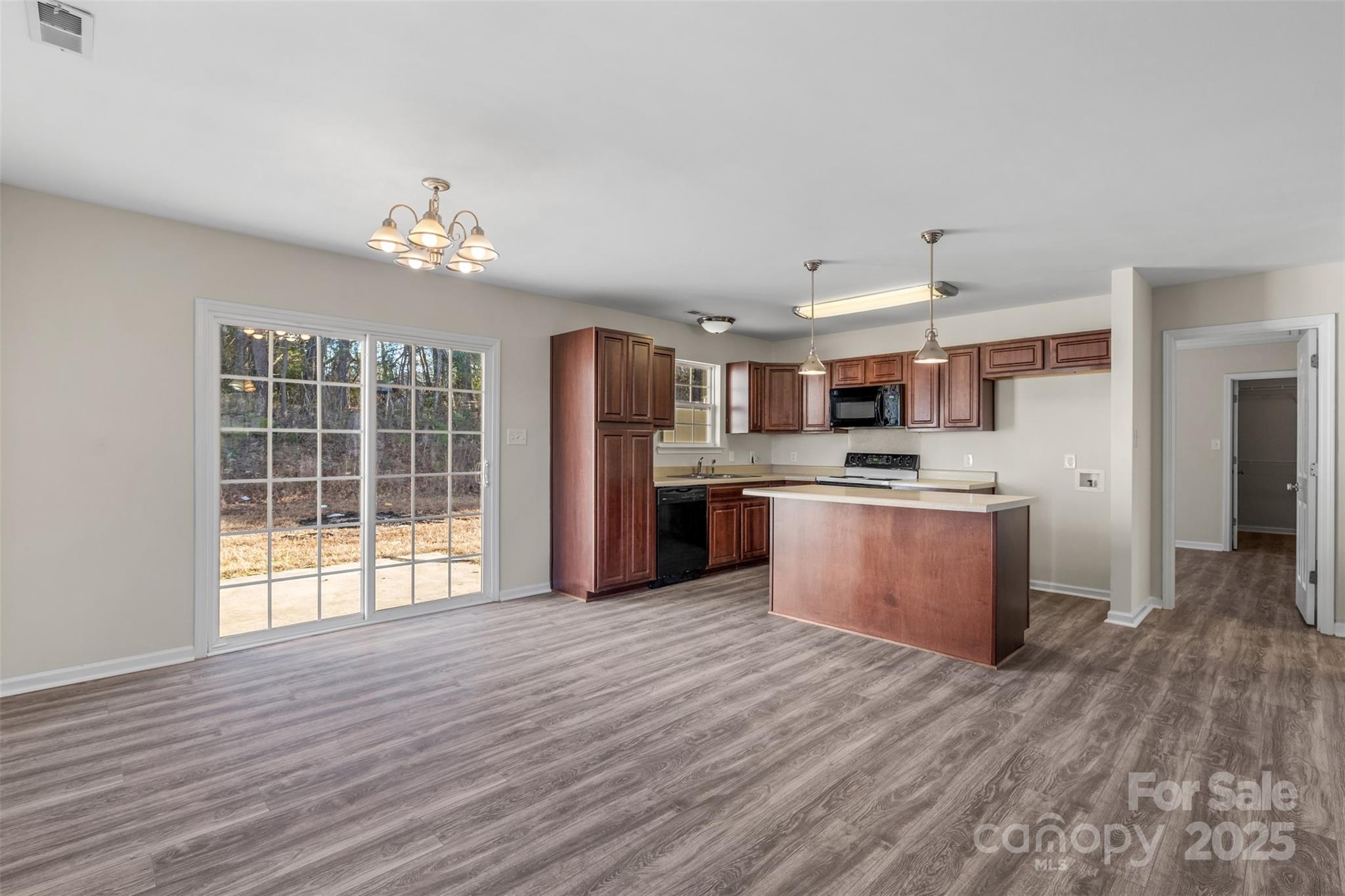 3065 Georgetown Road Lancaster, SC 29720 - Photo 12 of 26 a large kitchen with stainless steel appliances kitchen island a large counter top and wooden floors