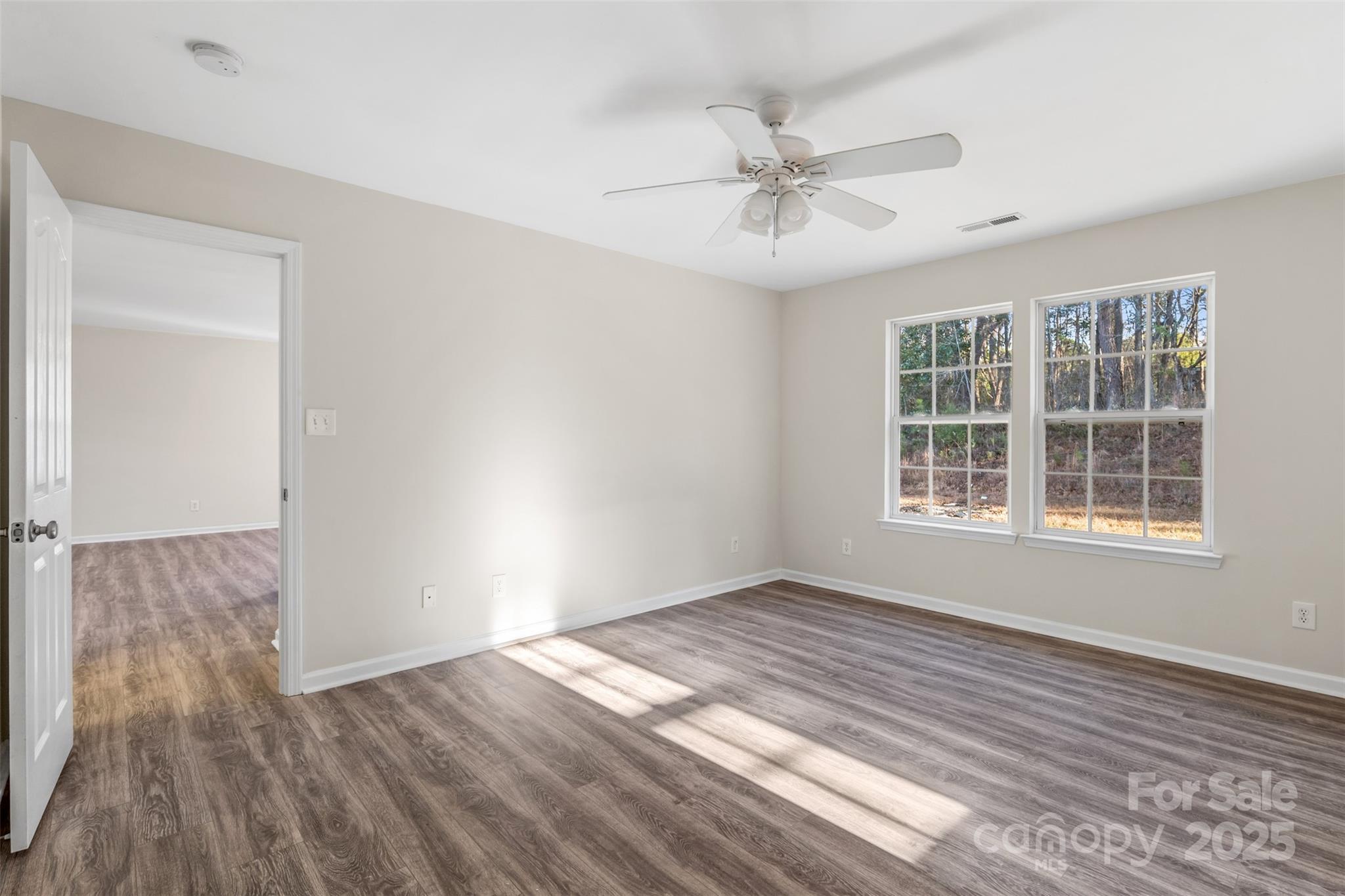 3065 Georgetown Road Lancaster, SC 29720 - Photo 18 of 26 an empty room with wooden floor fan and windows