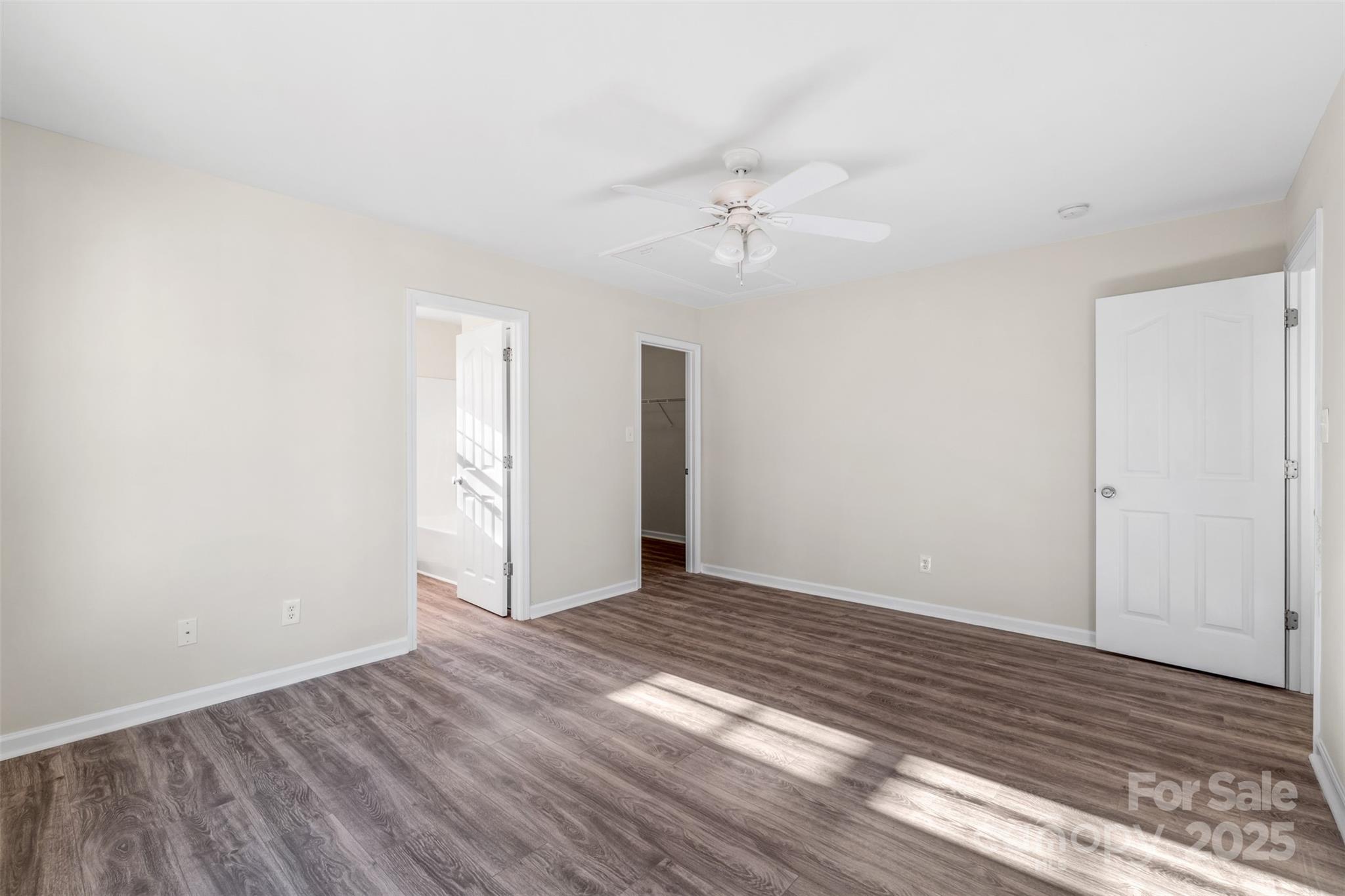 3065 Georgetown Road Lancaster, SC 29720 - Photo 20 of 26 a view of an empty room with wooden floor and a ceiling fan