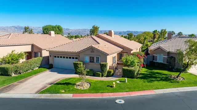 a aerial view of a house with a yard and potted plants