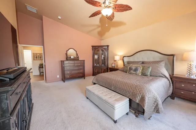 a bedroom with a bed and a chandelier