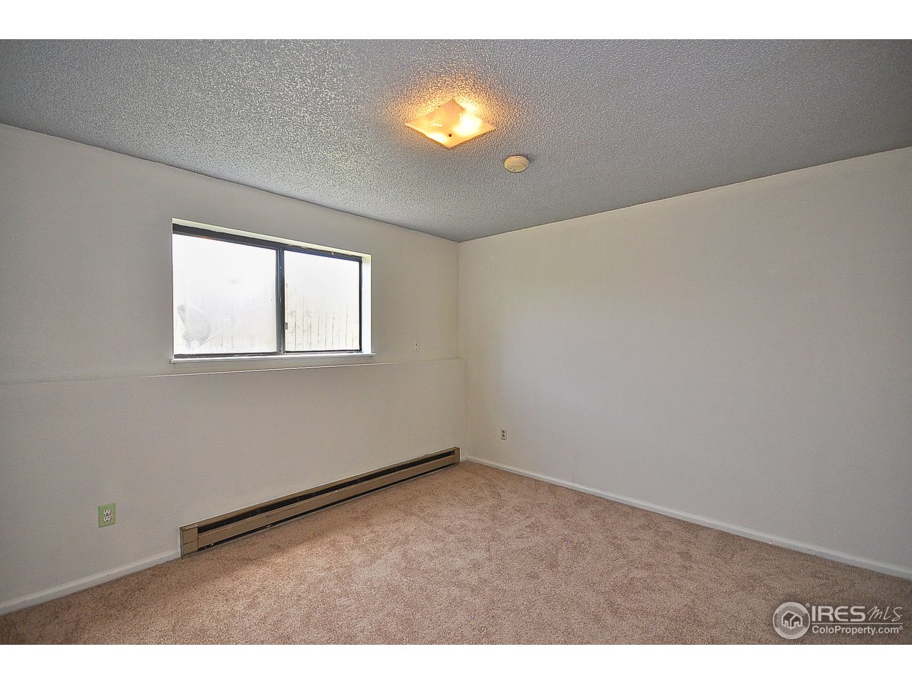 2628 Redwing Road, Unit 2A Fort Collins, CO 80526 - Photo 12 of 16 a view of an empty room with a window