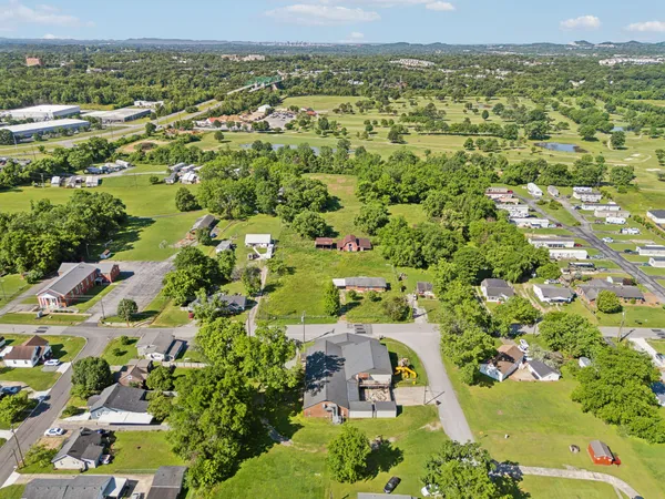 an aerial view of residential houses with outdoor space and street view