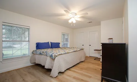 a bedroom with a large bed and a chandelier