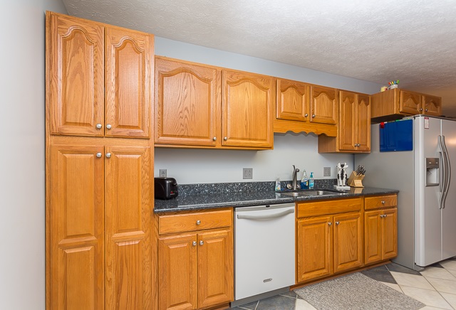 2001 Spitzer Road Broadway, VA 22815 - Photo 8 of 38 a kitchen with stainless steel appliances granite countertop a refrigerator a sink dishwasher and wooden cabinets with wooden floor
