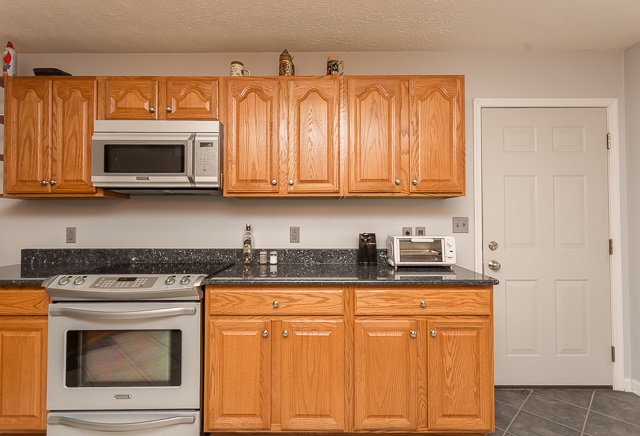 2001 Spitzer Road Broadway, VA 22815 - Photo 10 of 38 a kitchen with granite countertop white cabinets and stainless steel appliances