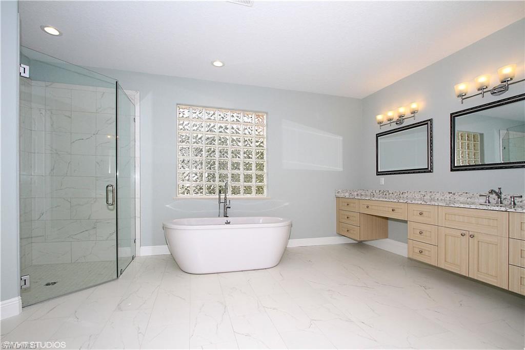 464 Terracina Way Naples, FL 34119 - Photo 11 of 35 New custom tiled shower with glass shower doors.