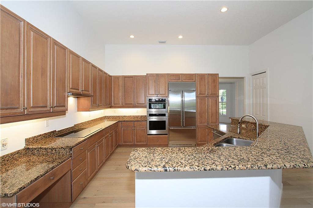 464 Terracina Way Naples, FL 34119 - Photo 14 of 35 Gourmet kitchen with plenty of cabinets and counter space.