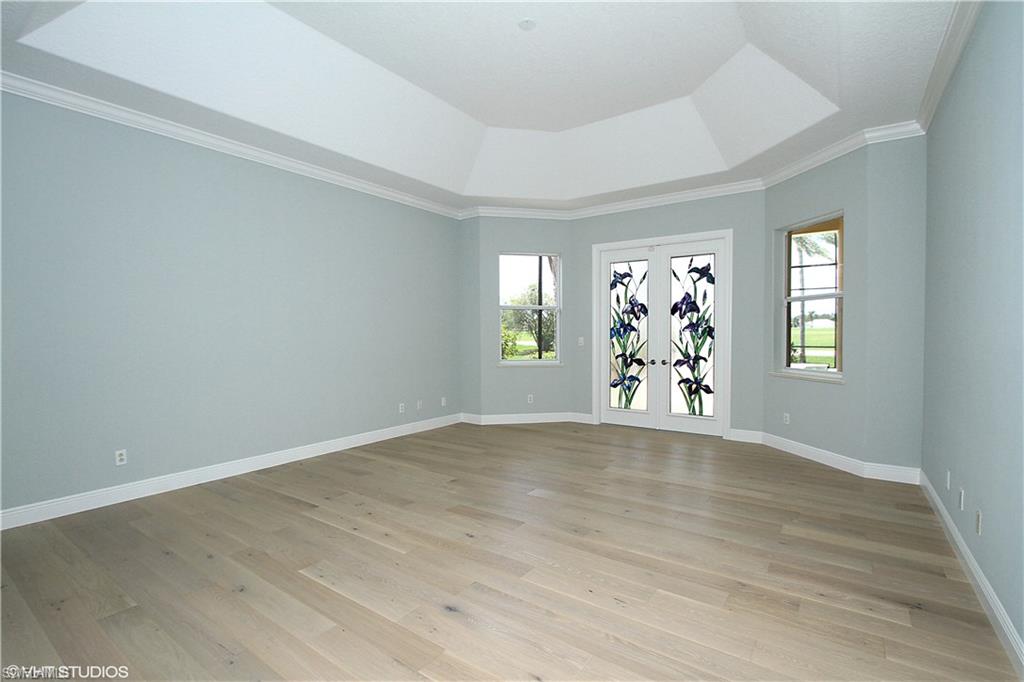 464 Terracina Way Naples, FL 34119 - Photo 9 of 35 Spacious master with leaded glass French Doors out to the lanai!