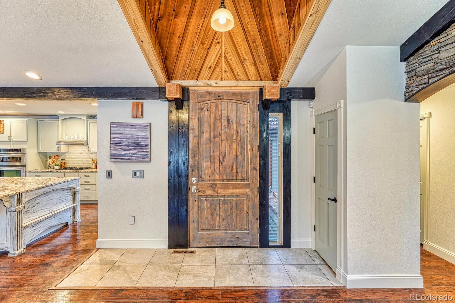 8224 Sweet Water Road Lone Tree, CO 80124 - Photo 3 of 38 a view of entryway with a door and wooden door
