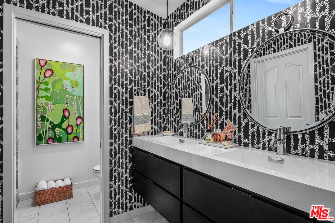 3516 Shoreheights Drive Malibu, CA 90265 - Photo 19 of 29 a bathroom with a sink and a mirror