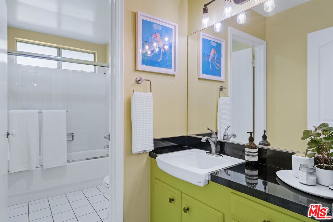 3516 Shoreheights Drive Malibu, CA 90265 - Photo 24 of 29 a bathroom with a granite countertop sink a mirror and shower