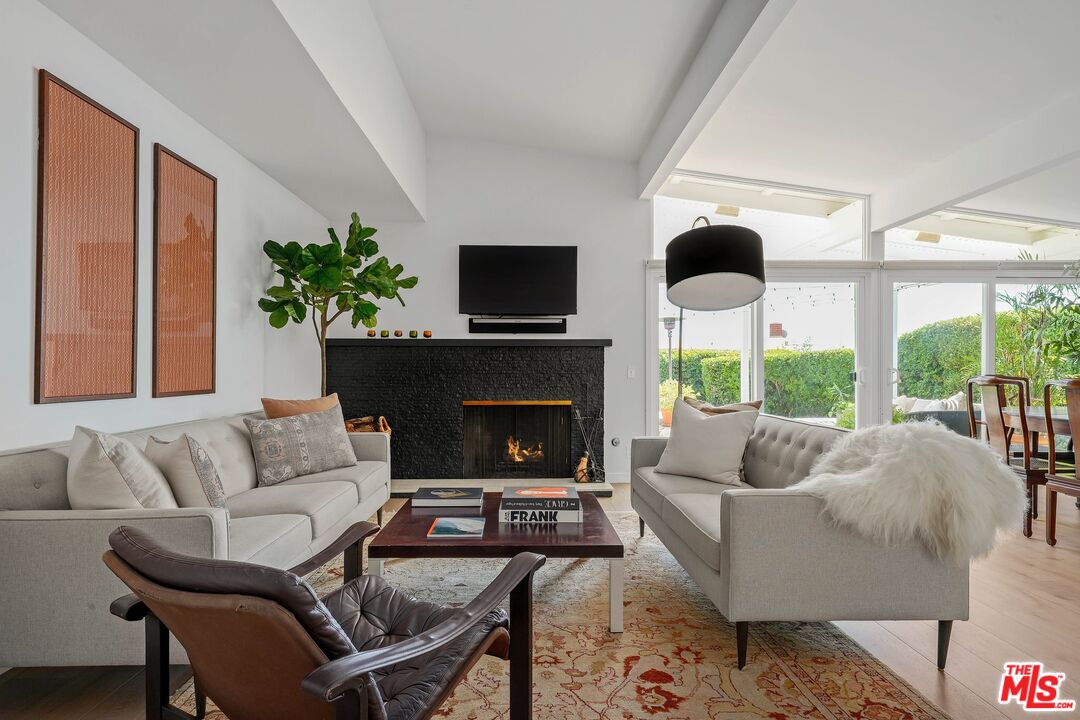 3516 Shoreheights Drive Malibu, CA 90265 - Photo 4 of 29 a living room with furniture fireplace and a large window