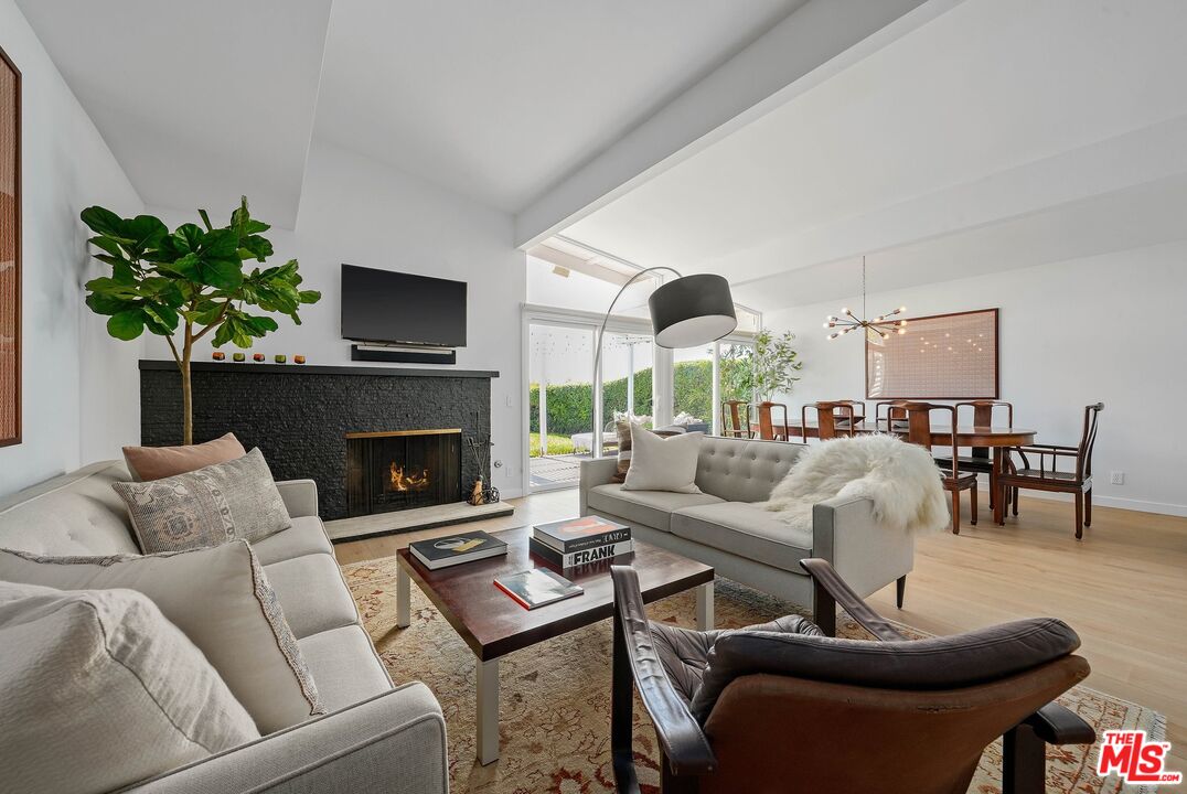 3516 Shoreheights Drive Malibu, CA 90265 - Photo 5 of 29 a living room with furniture a fireplace and a flat screen tv