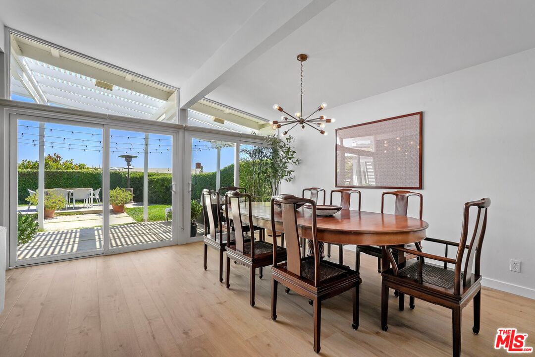 3516 Shoreheights Drive Malibu, CA 90265 - Photo 8 of 29 a view of a dining room with furniture large windows and wooden floor